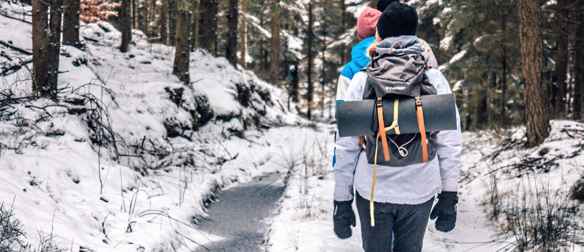 people hiking with backpacks in the winter