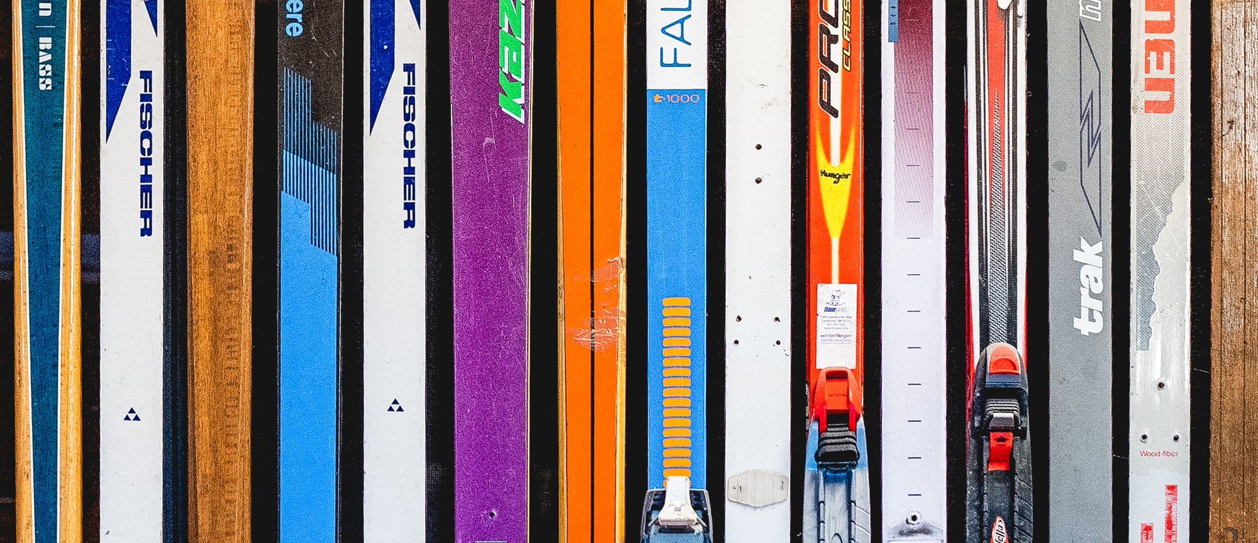 colorful vintage cross-country skis in a line