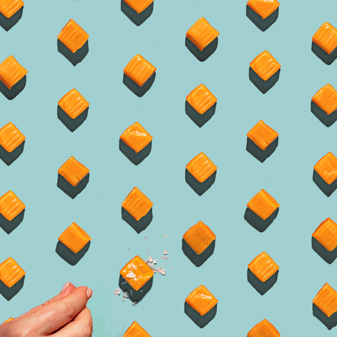 grid of caramels with sea salt on a bright teal background