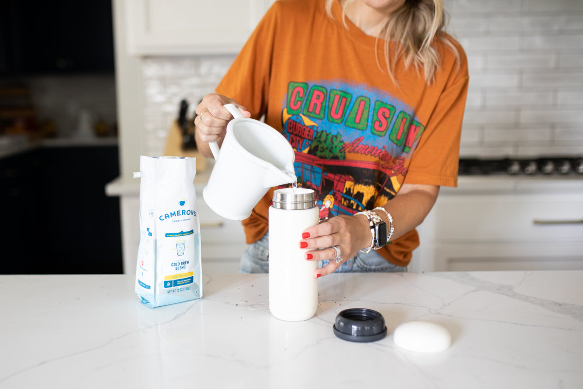 jen pouring water into a travel cold brew mug