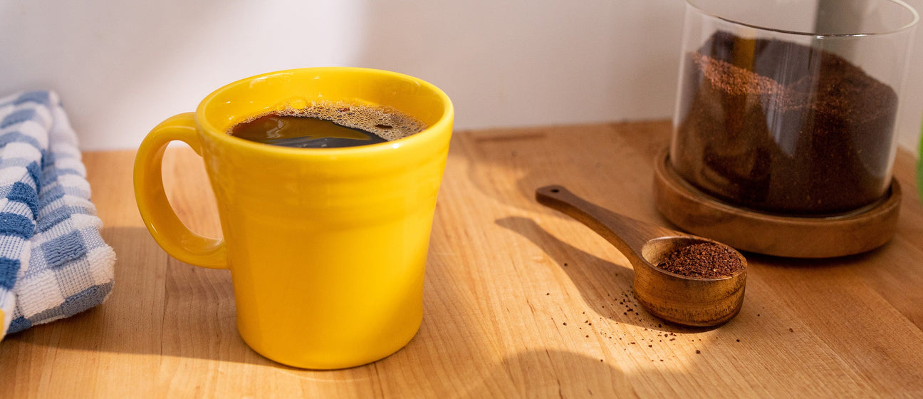 cup of smooth coffee in a bright yellow mug