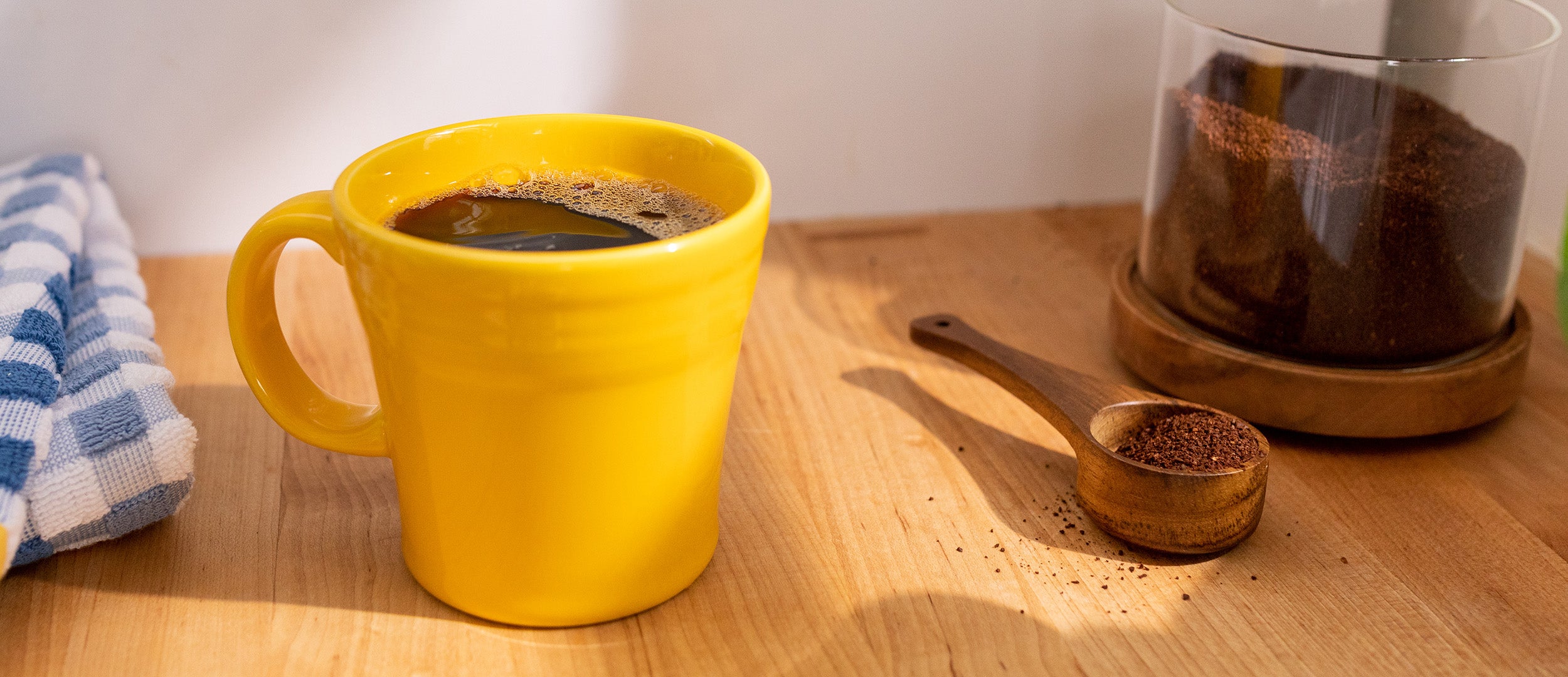 cup of smooth coffee in a bright yellow mug