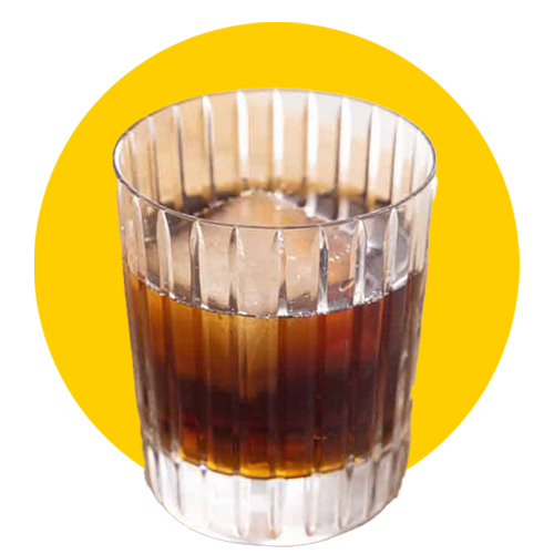 low ball glass with coffee drink and yellow background