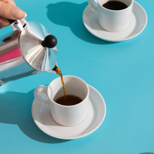cups of coffee with saucers on a blue background