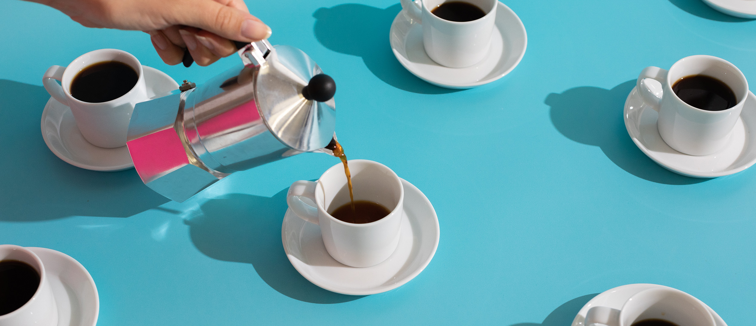 cups of coffee with saucers on a blue background