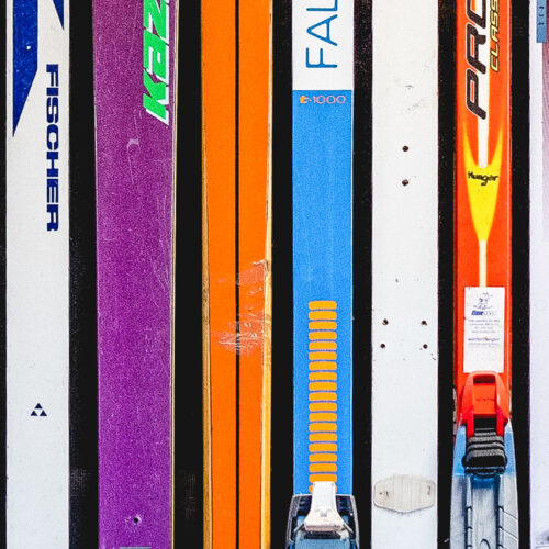colorful vintage cross-country skis in a line