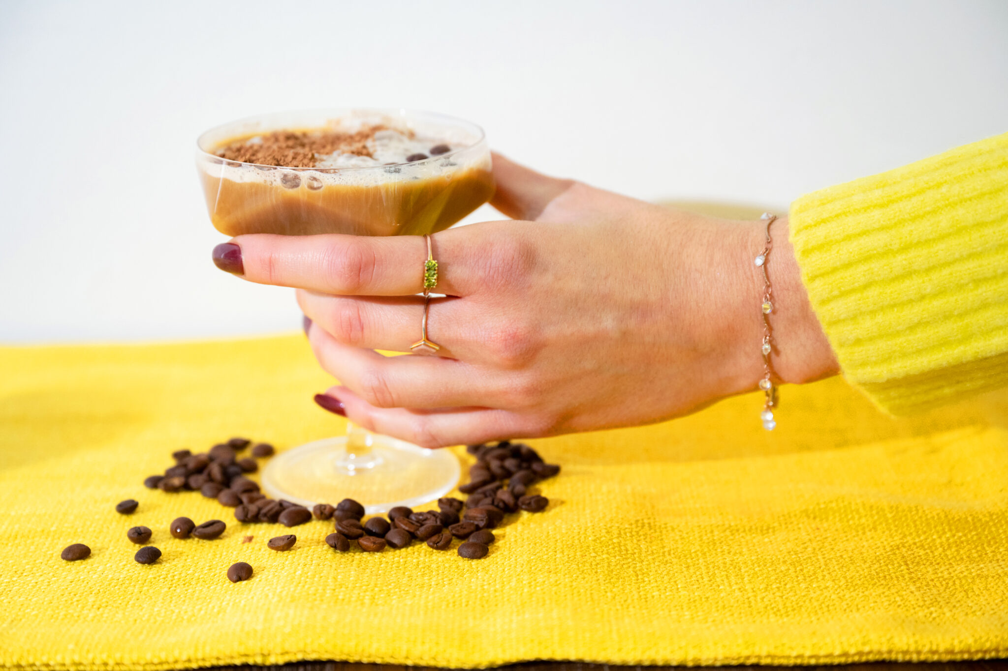 espresso martini being picked up by a hand